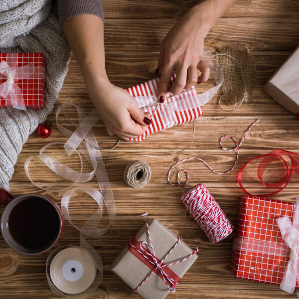 female hands wrapping christmas presents in paper 2023 11 27 05 13 03 utc