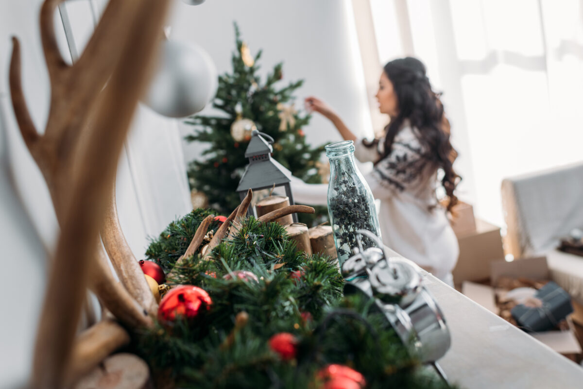 close up shot of holiday decor with woman decorati 2024 11 01 05 35 10 utc